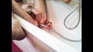Bi-guy using shower head, squirting water, enema