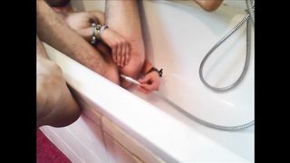 Bi-guy using shower head, squirting water, enema