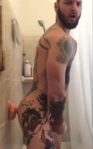 Tatted Hunk Fucks Dildo in Shower Until He Cums