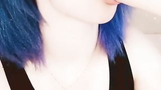 Girl with pink hair fucks herself with a black dildo.