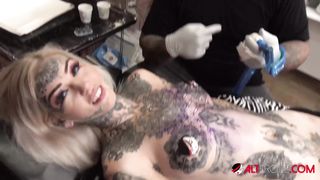 Sascha plays with Amber Luke while she gets tattooed