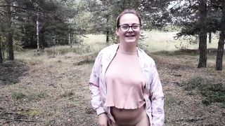 A teen baby girl pisses on the street in the forest and shows her boobs. Other people can see it.