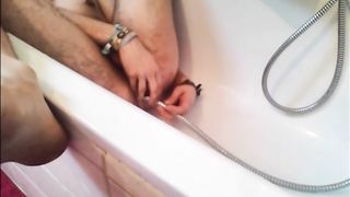 Bi-guy using shower head, squirting water, enema