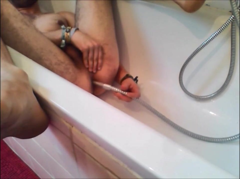 Bi-guy using shower head, squirting water, enema