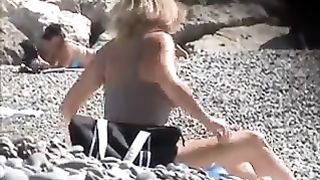beautiful milf undressing on the beach
