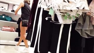 Candid voyeur teen showing ass cheeks while shopping