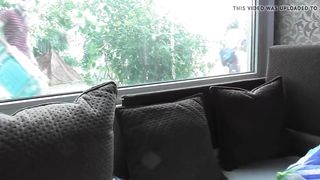 Hairy mature flashing in front of window